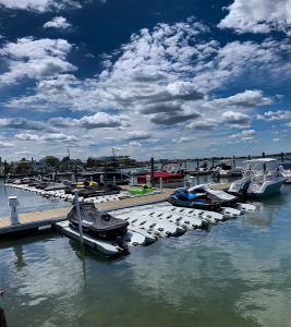 Jet Skis and Boats docked at EZ Dock ports on a picturesque marina